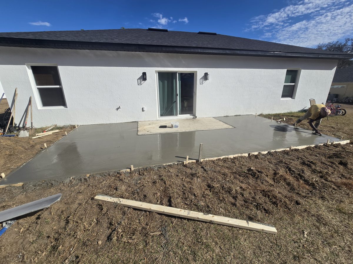 Fresh backyard patio slab being finished